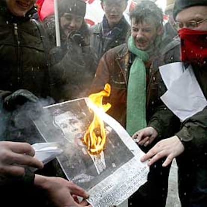 Un grupo de manifestantes queman una foto de Bush durante una protesta delante de la embajada de EE.UU. en Moscú.