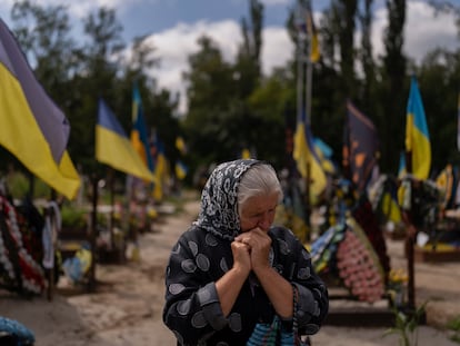 Svitlana Sushko, 62, sobs while visiting the grave of her youngest son, a Ukrainian soldier who was killed last year in the war against Russia, in Kyiv, Ukraine, Thursday, Aug. 3, 2023.