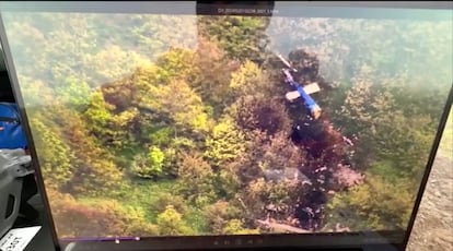 An image captured by a drone shows the remains of the helicopter at the crash site.