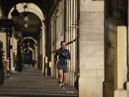 A man jogs in Paris, France, where members of the public can go out onto the street for an hour of physical activity a day under lockdown rules.