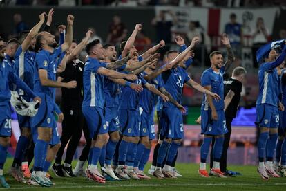 The Slovenia players celebrate the draw against England.