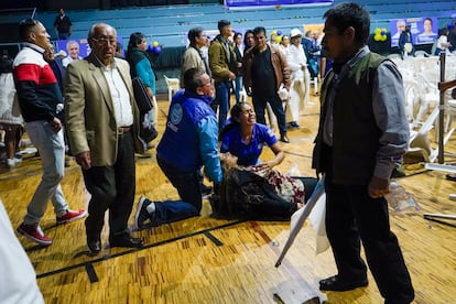 A supporter of presidential candidate Fernando Villavicencio lies wounded after Villavicencio was shot to death while at a campaign rally outside a school in Quito, Ecuador, Wednesday, Aug. 9, 2023. 