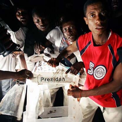 Seguidores de Préval muestran urnas con votos de su candidato halladas en un vertedero de Puerto Príncipe.