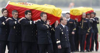 Miembros de la Armada llevan en hombros los féretros de dos de los cuatro militares muertos en Haití a su llegada a la base de Rota.