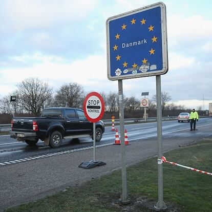 PADBORG, DENMARK - JANUARY 06:  Danish police conducting spot checks on incoming traffic from Germany stand at the A7 highway border crossing on January 6, 2016 near Padborg, Denmark. Denmark introduced a 10-day period of passport controls and spot checks on Monday on its border to Germany in an effort to stem the arrival of refugees and migrants seeking to pass through Denmark on their way to Sweden. Denmark reacted to border controls introduced by Sweden the same day and is seeking to avoid a backlog of migrants accumulating in Denmark. Refugees still have the right to apply for asylum in Denmark and those caught without a valid passport or visa who do not apply for asylum are sent back to Germany.  (Photo by Sean Gallup/Getty Images)