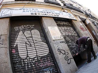 Un trabajador del Centro Joven de Anticoncepción y Sexualidad, en la calle de San Vicente Ferrer, echa el cierre al acabar la jornada.