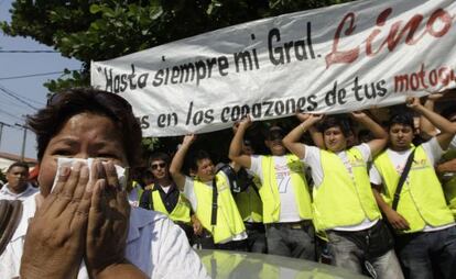 Supporters of Lino Oviedo hold a banner outside a morgue that reads: &quot;Until forever my general.&quot;