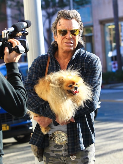 Mickey Rourke walks the streets of Los Angeles with one of his beloved dogs in January of 2017