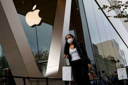 A customer exits after picking up Apple's new 5G iPhone 12 that went on sale at an Apple Store in Brooklyn, New York