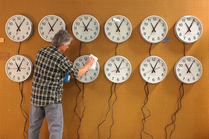 Man cleaning clocks at the Electric Time Company in Medfield, Massachussetts.