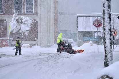 A worker plows snow on a street, Tuesday, March 14, 2023, in Pittsfield, Massachussetts.