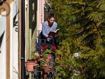 Una joven lee en el balcón de su casa, en Barcelona, durante el confinamiento.