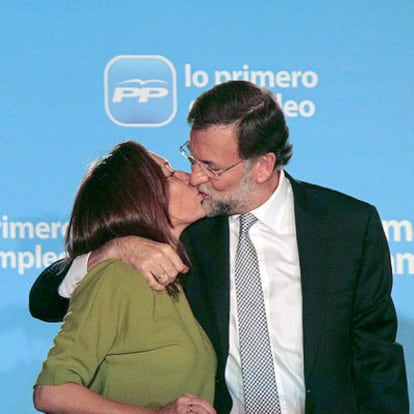 El líder del PP, Mariano Rajoy, besa anoche a su esposa en la sede del partido.