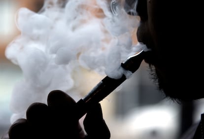 In this April 23, 2014 file photo, a man smokes an electronic cigarette in Chicago.