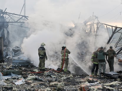 Ukrainian rescuers work at the site where debris from a missile fell on a residential area in Kyiv, Ukraine, on September 21, 2023.