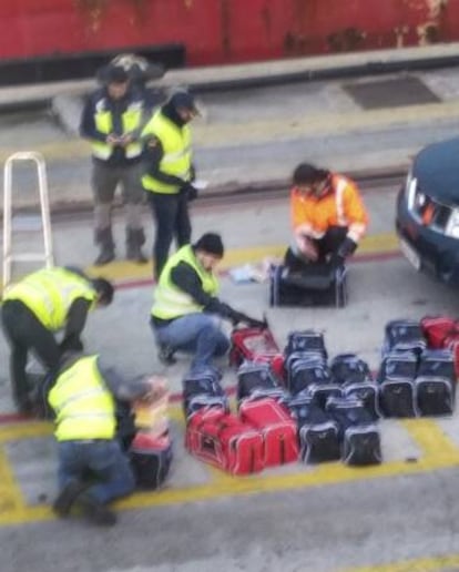 Officers searching bags containing drugs during the last raid headed by 'Cale'.