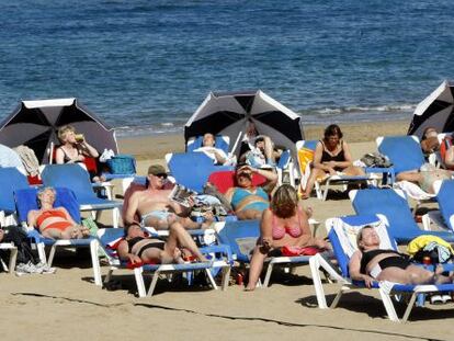 Varios turistas toman el sol en la playa de Las Canteras en Las Palmas de Gran Canaria.