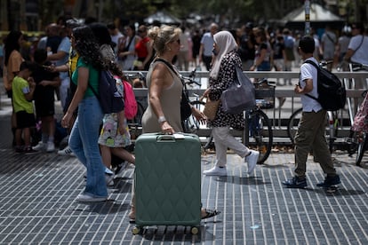 Turistas con maletas en la Rambla de Barcelona.