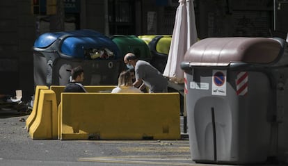 Una terrassa d'un bar al carrer Aragó, situada entre contenidors. 