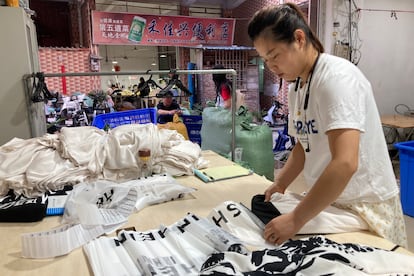 A woman packs clothes for the Shein brand at a factory in Nancun, a town in Guangzhou, Guangdong Province, south China on April 16.