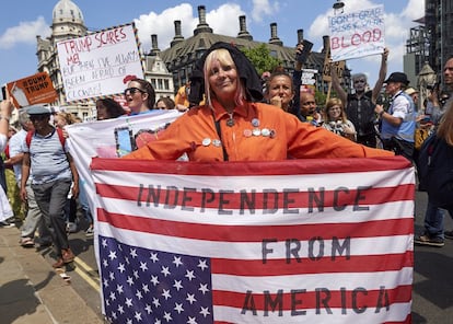 Una manifestante muestra una bandera donde se puede leer "independencia de América", durante una marcha anti Trump en Londres.