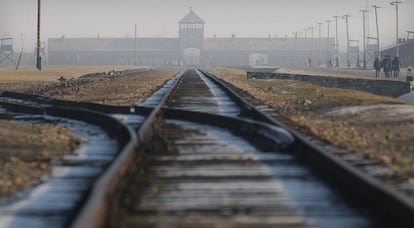 FILE - The Jan 17, 2005 file photo rails in the former Nazi death camp Auschwitz-Birkenau in Oswiecim, southern Poland. One of the black-uniformed men on the ramp where people arrived was likely SS guard Oskar Groening who goes on trial Tuesday, April 21, 2015 in a state court in the northern city of Lueneburg on 300,000 counts of accessory to murder. (AP Photo/Czarek Sokolowski, file)