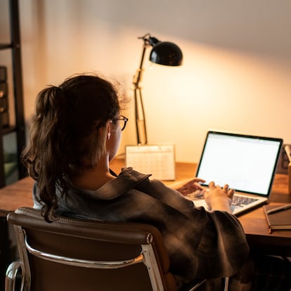 Teen girl doing homework on her laptop