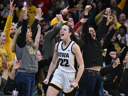 Iowa Hawkeyes guard Caitlin Clark celebrates setting the NCAA women's scoring record in a game against the Michigan Wolverines at Carver-Hawkeye Arena.