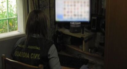 Una agente inspecciona archivos de pornografía infantil incautados.