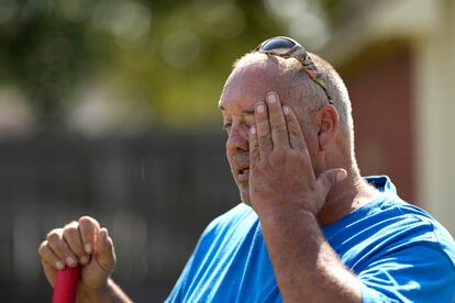 Robert Harris pauses to wipe his face while digging fence post holes Tuesday, June 27, 2023, in Houston.
