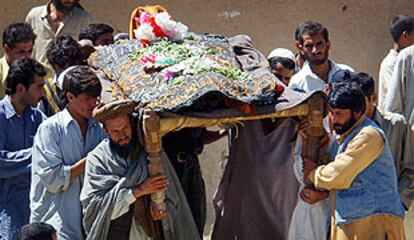Un grupo de afganos porta el cadáver de un joven muerto ayer en el atentado de Kabul.