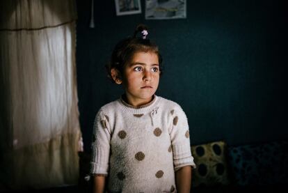 In this March 6, 2016 photo, Winda Farman Haji, a 5-year-old refugee from a town outside Malikiyah in northeast Syria, poses for a portrait inside the tent she shares with her family at Kawergosk refugee camp in Iraq. Winda was born in a village outside Malikiyah in the Kurdish part of northeastern Syria, where her father Sharif Farman Haji, 44 worked as a lorry driver on the Malikiyah-Qamishly route. They fled August 2012 but their troubles didnx92t end there. Her uncle, died fighting IS in Kobane in the ranks of the Iraqi Peshmerga.  (AP Photo/Alice Martins)