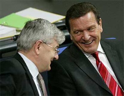 Gerhard Schröder, a la derecha, y el ministro de Exteriores, Joschka Fischer, charlan ayer en el Parlamento alemán.