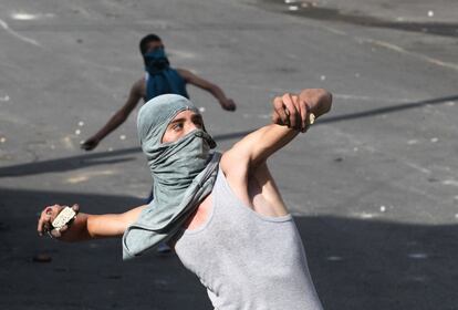 Palestinos lanzan piedras contra los soldados israelíes en Hebrón (Cisjordania).