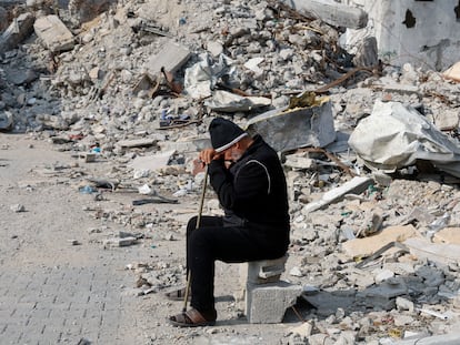 A Palestinian man sits next to the rubble of a house destroyed by an Israeli attack in Rafah, southern Gaza, on Tuesday.