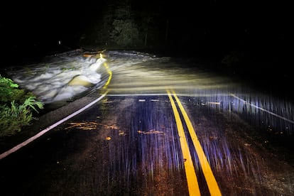 Floodwaters wash over Guy Ford Road bridge on the Watauga River as Hurricane Helene approaches in the North Carolina mountains, in Sugar Grove, North Carolina, U.S. September 26, 2024. 