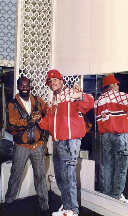 LL Cool J in a red, Gucci-label jacket poses alongside legendary stylist Dapper Dan in the 1980s.