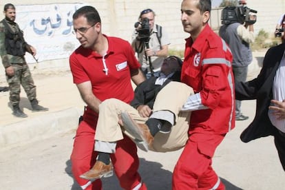 Miembros de la Media Luna Roja trasladan a un ciudadano durante una operaci&oacute;n de evacuaci&oacute;n en Muadamiya, una zona rural de Damasco. 