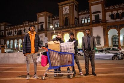 Abdullah Abass, Iván Caro, Mohamed Sawba y Bubaca Biaro (de izquierda a derecha) entregan ropa y mantas a personas sin hogar.