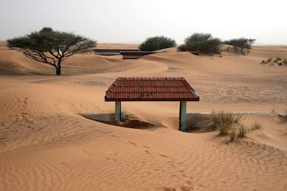 A house's entrance gate is buried under the sand at the Bedouin village of al-Ghuraifabout 100 km, 62 miles, southeast of Sharjah, United Arab Emirates, Sunday, July 9, 2023.