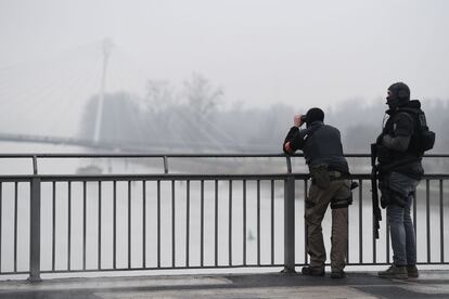Un miembro de la unidad de la policía francesa mira a través de los prismáticos desde el Puente de Europa, en Estrasburgo (Francia). El gobierno francés ha elevado el nivel de alerta de seguridad y reforzando los controles fronterizos.