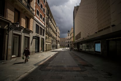 Un hombre con mascarilla por el coronavirus camina por la calle de Preciados vacía, durante el primer estado de alarma.