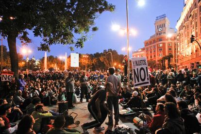 Los manifestantes se sientan en corrillo para en asamblea discutir y proponer alternativas a los Presupuestos que los diputados debaten al mismo tiempo en el Congreso de los Diputados.