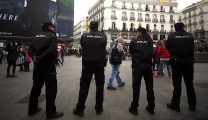 Police officers watching Madrid's central Sol Square on New Year's Eve.