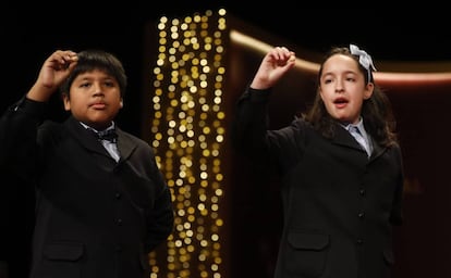 Children at Madrid's San Ildefonso school sing out the winning lottery numbers.