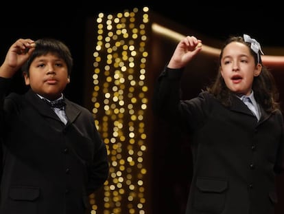 Children at Madrid's San Ildefonso school sing out the winning lottery numbers.