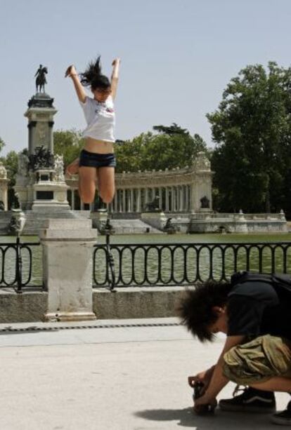 Dos jóvenes asiáticos ante el lago del parque del Retido.