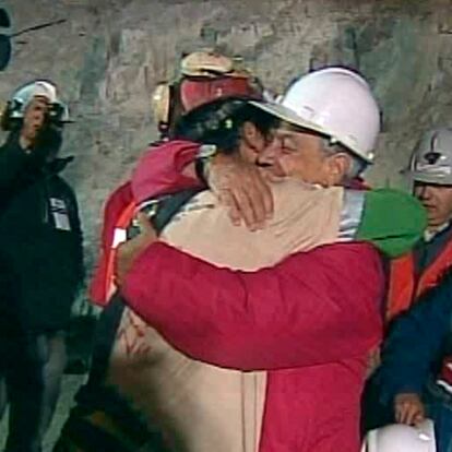 In this screen grab taken from video, Florencio Avalos, the first miner to be rescued, left, is embraced by Chilean President Sebastian Pinera after his rescue Tuesday, Oct. 12, 2010 at San Jose Mine near Copiapo, Chile. (AP Photo)