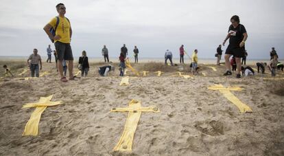 Cruces amarillas hechas con toallas en la playa de Mataró.