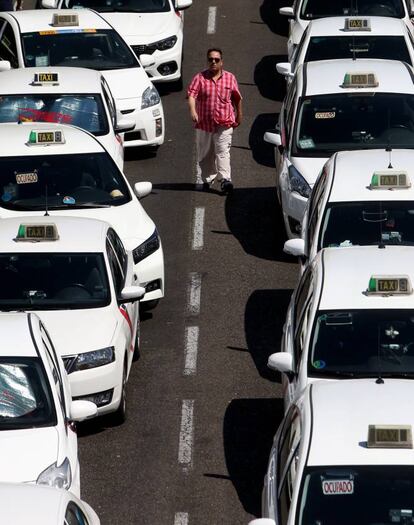 Un taxista camina entre los vehículos durante la concentración frente al Ministerio de Fomento en Madrid.